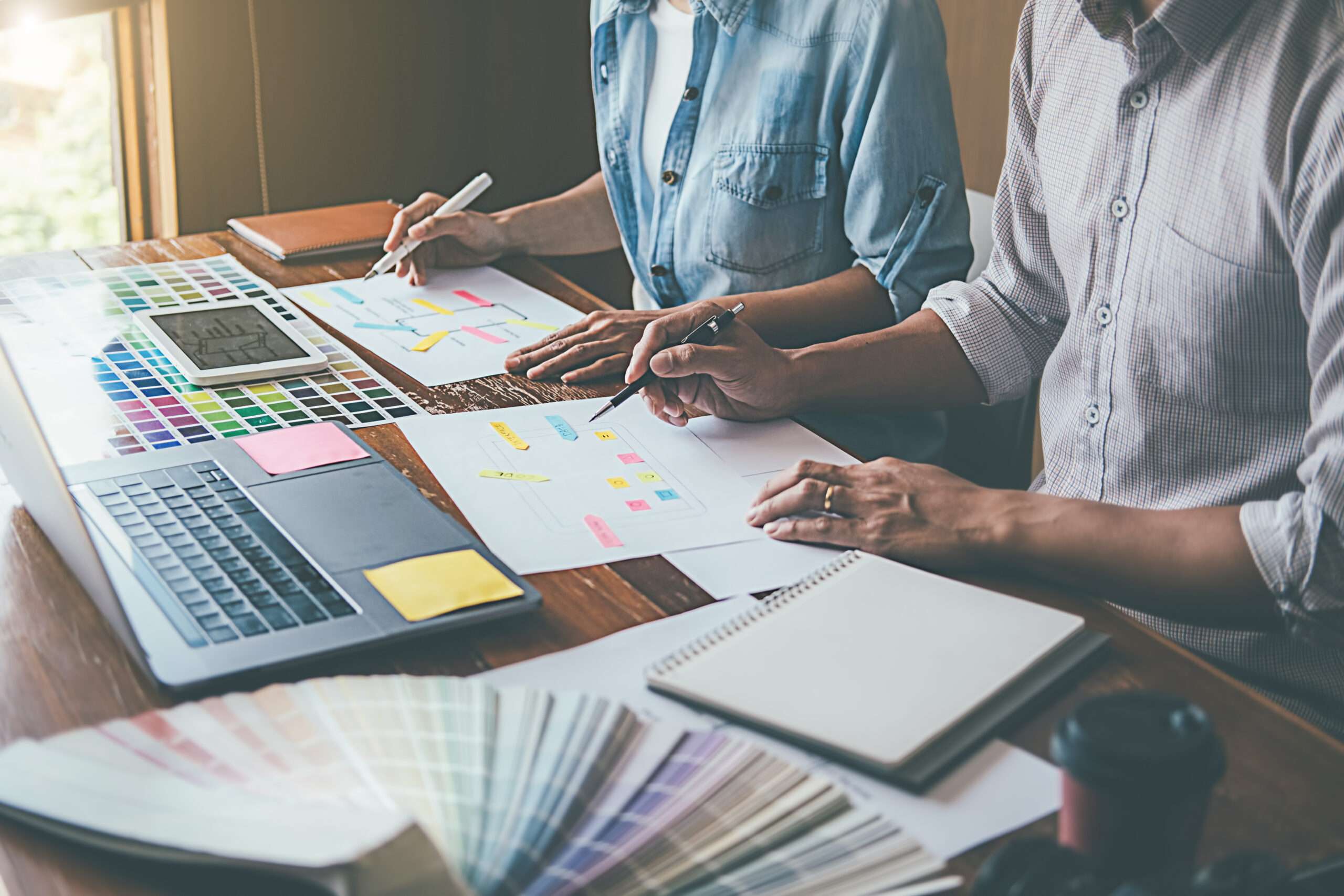 An image of two people sitting and working together on planning their web design process in East Texas.